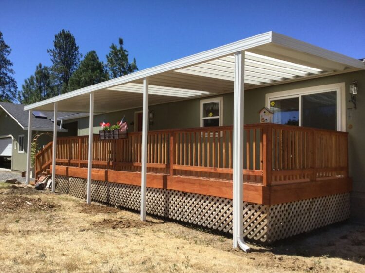 Wooden deck with white patio cover installed by professional contractors