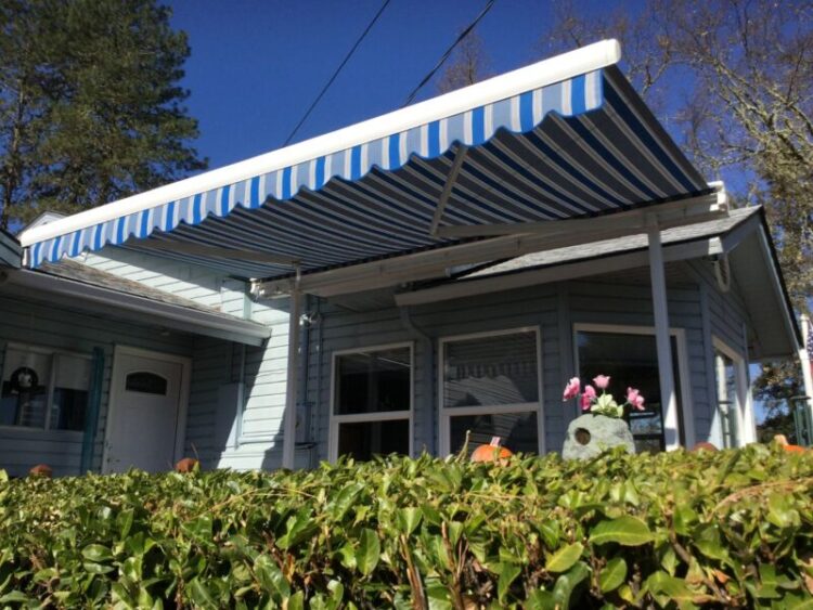 Retractable patio cover installed by professionals over a home’s porch